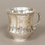 A small Chinese silver mug Of waisted form, decorated with vignettes of various birds and foliage,