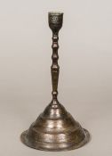 A 16th century Persian candlestick The slender knopped stem standing on a spreading domed foot,