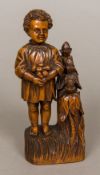 A 19th century carved wooden sewing companion Formed as a young child collecting fruit,