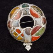 A Victorian Scottish hardstone set unmarked silver plaid brooch Of typical circular form with