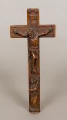 An 18th century carved wooden crucifix The reverse with sliding reliquary panels with stitched and