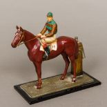 An early 20th century cold painted spelter table lighter Formed as a racehorse with jockey up,