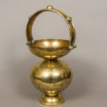 A 19th century finely engraved Indian brass bucket Of double gourd form with boss mounted loop