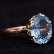 A 14 K gold and aquamarine ring With claw set facet cut oval aquamarine above the pierced shoulders.