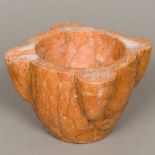 A carved rouge marble mortar Of typical form. 22 cm wide.