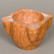 A carved rouge marble mortar Of typical form. 22 cm wide.