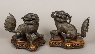 A pair of Chinese 18th/19th century patination bronze models of fo dogs Each typically modelled,