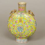 A Chinese porcelain twin handled moon flask Decorated with lotus strapwork on a yellow ground,