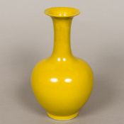 A Chinese porcelain vase The flared neck above the main bulbous body, with allover yellow ground,