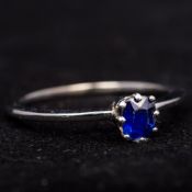 A platinum and sapphire solitaire ring The shank of flattened form. 5 mm high.