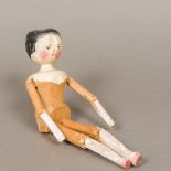 A 19th century naive carved wooden peg doll Of typical form, with painted features. 29 cm high.