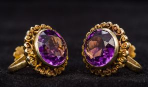 A pair of 15 ct gold amethyst set clip-on earrings Each of domed circular form.