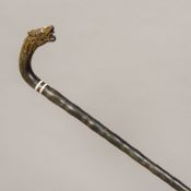 A Chinese carved horn sectional walking stick The handle worked as a dragon's mask. 94 cm long.