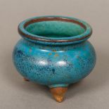 A Chinese pottery censer Of three legged squat circular form with blue glazed ground. 8 cm high.