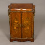 A 19th century Continental gilt metal mounted marquetry inlaid serpentine cabinet The hinged doors