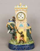 A large majolica pottery clock Formed as an elephant being ridden by a monkey smoking a pipe,