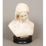 A 19th century carved marble bust Modelled as a young lady wearing a florally embroidered headdress,