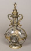 A 19th century Continental silver mounted clear glass decanter The figural finial screw lid above