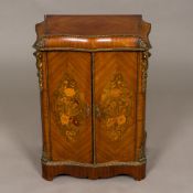 A 19th century Continental gilt metal mounted marquetry inlaid serpentine cabinet The hinged doors