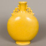 A Chinese yellow ground porcelain moon flask Of typical form, with pierced handles,