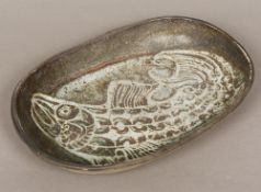A pottery dish Of rounded rectangular form, decorated within the glaze with a fish. 43.5 cm wide.