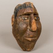 A late 19th/early 20th century tribal, probably South Seas, carved and painted coconut,