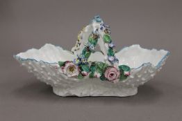 A 19th century florally encrusted porcelain basket