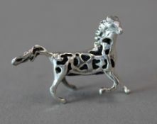 A small silver horse form pin cushion