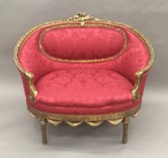 A 19th century French giltwood framed upholstered settee, of small proportions,