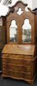 An 18th century style walnut mirrored door bureau bookcase