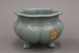 A Chinese porcelain celadon glazed censer, of lobed form with calligraphic panel.