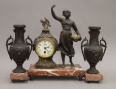 A three piece figural clock set