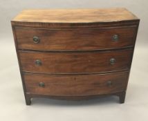 A 19th century mahogany bow front three drawer chest of drawers. 98.