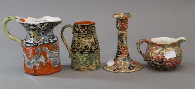 Four pieces of Mason's Ironstone comprising of three jugs and a candlestick