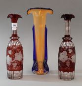 A pair of Ruby Flash glass decanters (lacking stoppers) and an Art glass vase