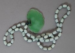 A celadon jade necklace and pendant