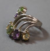 A silver peridot and amethyst ring