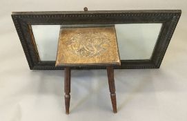 A low stool with carved seat worked with poppies; together with an oak framed mirror.