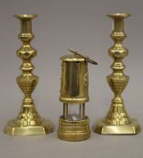 A pair of 19th century brass ejector candlesticks and a miner's type lamp