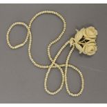 A Victorian ivory bead necklace with carved ivory floral pendant