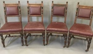 A set of four late Victorian leather upholstered walnut dining chairs