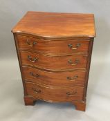 An early 20th century serpentine mahogany chest of drawers of small proportions