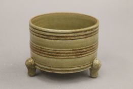 A Chinese porcelain censer, with ribbed body and all over olive green glaze.