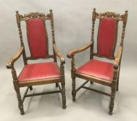 A pair of carved oak open armchairs