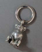 A silver rattle formed as a teddy bear