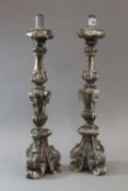 A pair of silvered carved wood pricket stick lamp bases