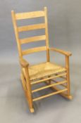 A modern rush seated ladder back rocking chair