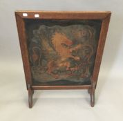 A Victorian leather inset oak fire screen