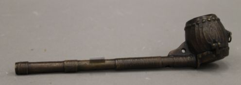 A bronze opium pipe