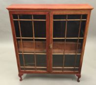 A glazed floor standing bookcase